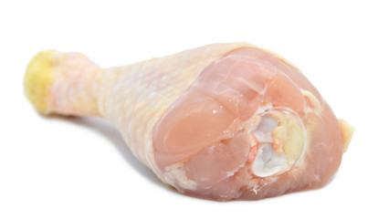closeup of raw chicken leg isolated on white background