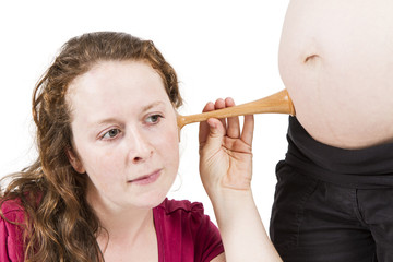 midwife listening at human belly