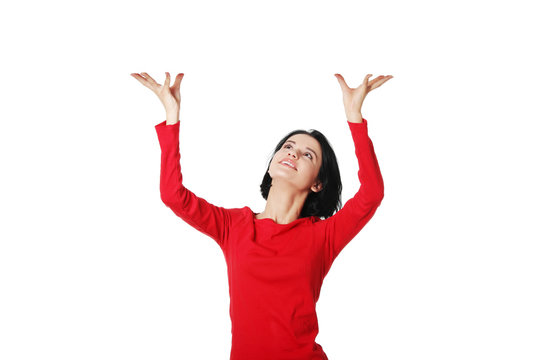 Woman Is Holding Something Abstract Above Her Head.