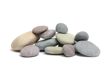 Stacked colorful sea stones on white background