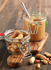 Peanuts and Fresh peanut butter on wooden background