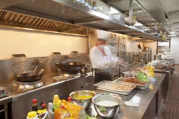 Chef cooking at commercial kitchen - hot job!