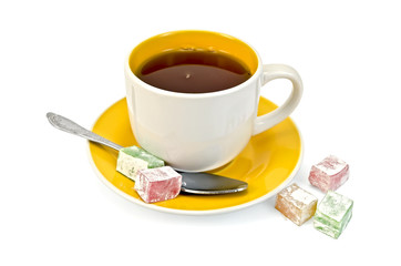 Tea in yellow cup with lokum