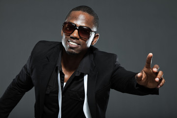 Cool black american man in dark suit. Studio fashion shot.