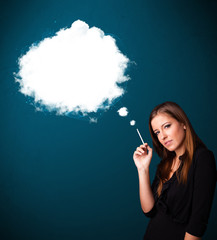 Obraz premium Young woman smoking unhealthy cigarette with dense smoke