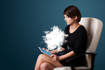Young woman looking at modern tablet with abstract cloud