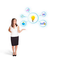 Young woman presenting light bulb with colorful graphs and diagr