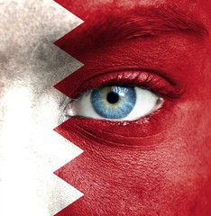 Human face painted with flag of Bahrain