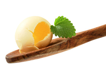 Butter curl on a wooden spoon