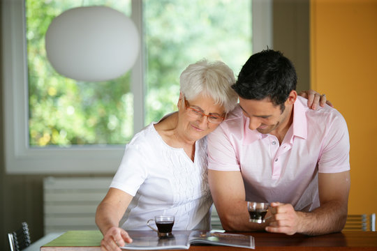 Senior Woman Drinking Coffee With Her Son