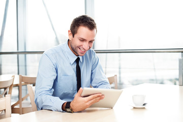 Fototapeta na wymiar Businessman with digital tablet smiling