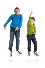 Fototapeta premium Two boys jumping on white background.