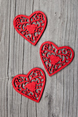 Fototapeta na wymiar Three hearts on wooden background