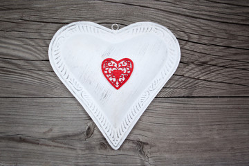 Big white heart on wooden background