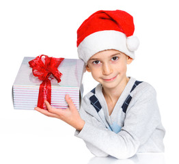 Little boy in Santa's hat with gift box