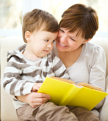 Mother is reading book for her son