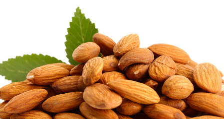tasty almonds nuts with leaves, isolated on white