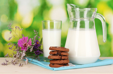 Pitcher and glass of milk with cookies