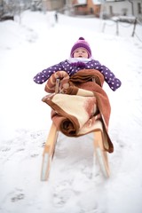 baby  on a snow sled