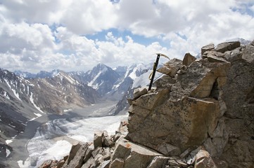Ice axe in rock over glacier Dugoba, Pamir-alay, Kyrgyzstan