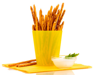 Tasty crispy sticks in yellow plastic cup isolated on white