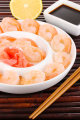 Prawns on plate with chopsticks and sauce