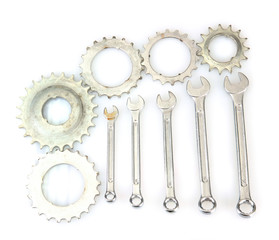 Metal cogwheels and spanners isolated on black