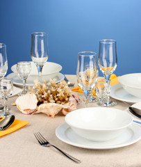 Table setting in white and yellow tones on color  background