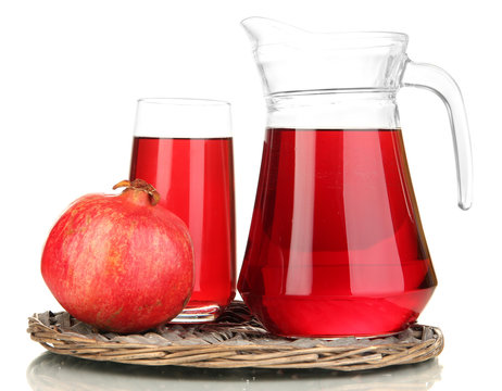Full glass and jug of pomegranate juice and pomegranate