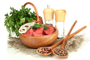 Raw beef meat in bowl with herbs and spices isolated on white