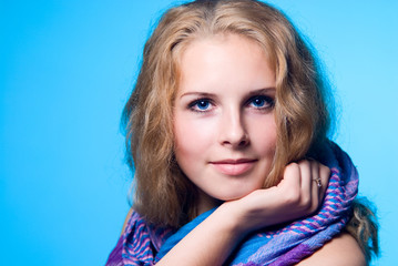 Close-up portrait of a charming girl with a scarf