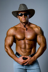 Muscular male in a hat and sunglasses