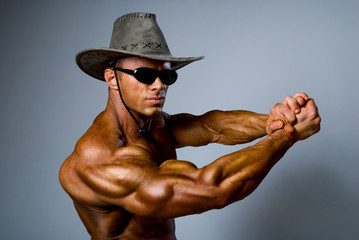 Muscular male in a hat and sunglasses