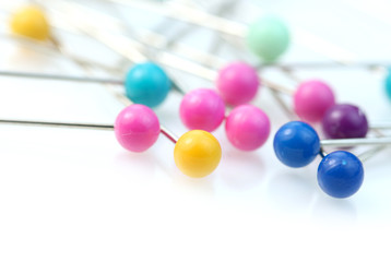 Colorful pins against white background