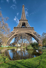 Wonderful wide angle view of Eiffel Tower with lake and vegetati