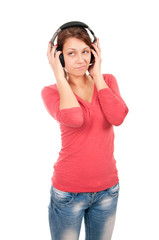Fototapeta premium Happy young woman with headphones isolated over a white backgrou