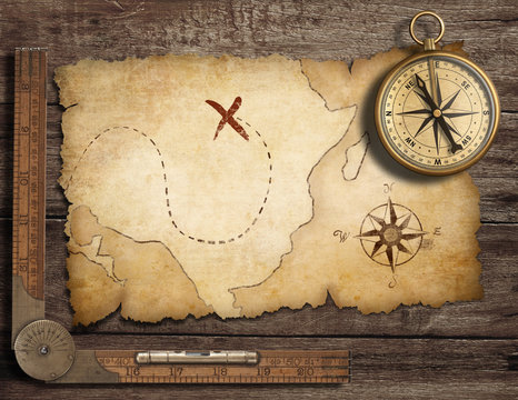Fototapeta aged brass antique nautical compass on table with old treasure m