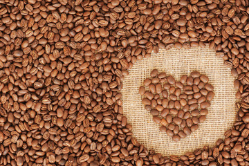 heart coffee frame made of coffee beans on burlap texture
