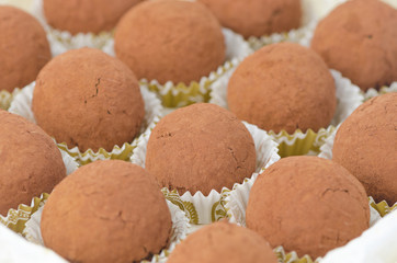 Fototapeta na wymiar box of chocolate truffles, selective focus on center