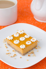 Pumpkin cake, decorated with flowers made of whipped cream