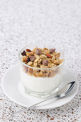 Yogurt and granola in a small glass beaker portions