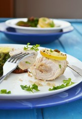 turkey roll with mangolde salad and lemon on the dish