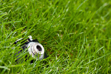 SLR camera on green grass