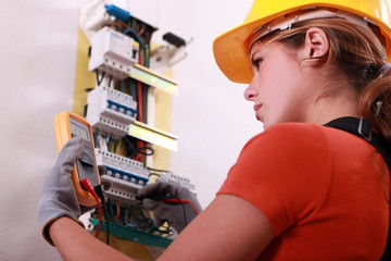 Woman measuring electrical current