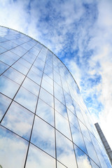 Fototapeta na wymiar highrise glass building with sky and clouds reflection