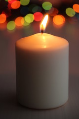 candle on wooden table with bright background