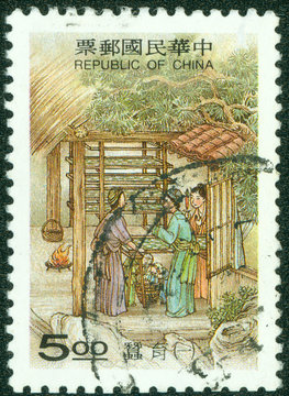 stamp shows a traditional painting of silkworm breeding