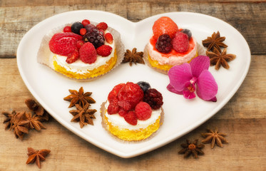 berries cupcakes in heart shape plate
