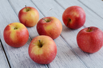 Ripe apples on shabby wooden table