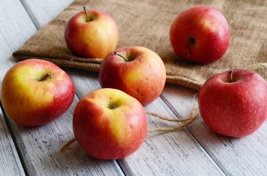 Ripe apples on shabby wooden table